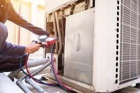Technician performing AC repair in Lahore on a split air conditioner